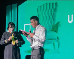 Pareja en el escenario con el logo de Universidad de la Vida